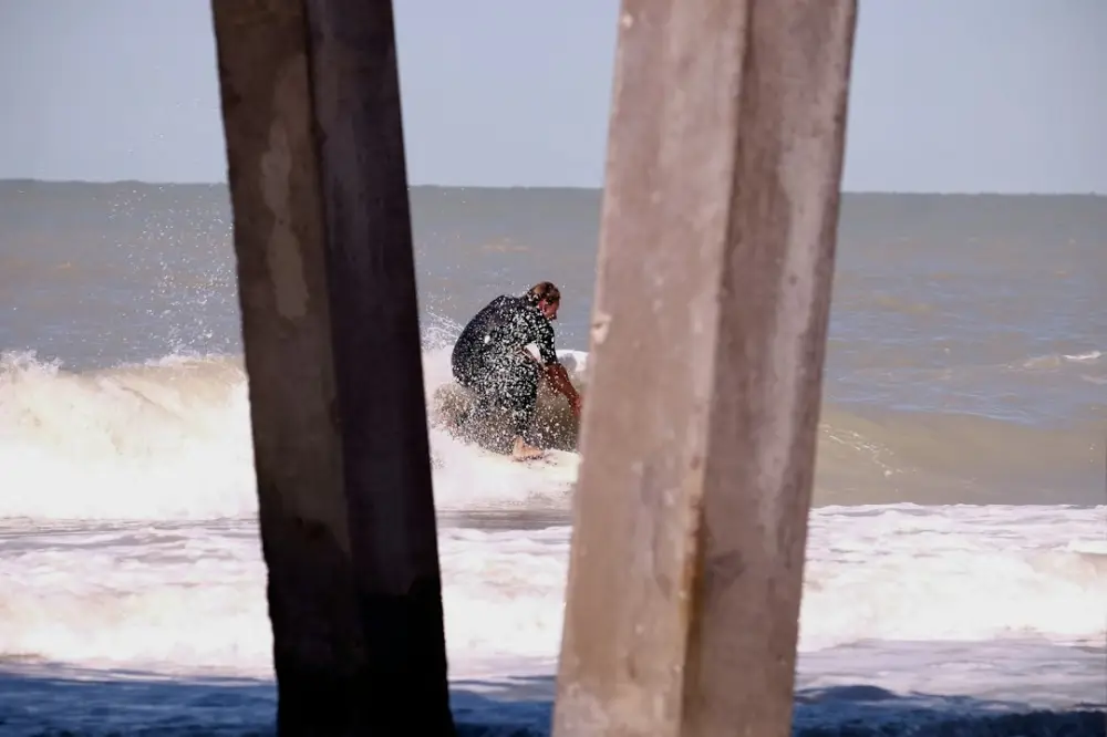 Man playing surfboard during daytime, illustrating getting around naples during winter stays